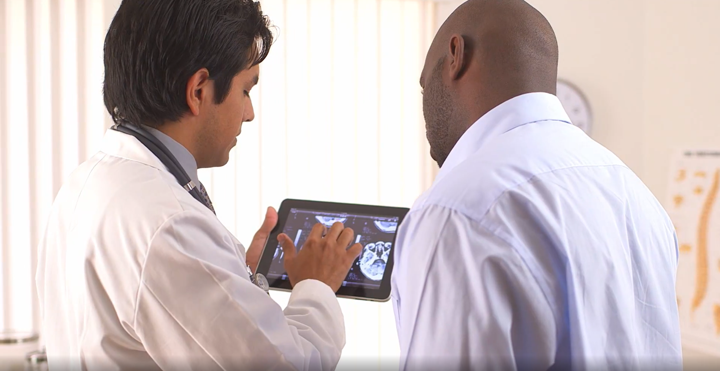 urgent care telehealth app - a doctor looking at a tablet with detailed patient analytics and health trends